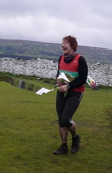 Lyn crossing the line at the Stanbury Splash 2009 to achieve her 65 races at 65 - Photo ©Dave Woodhead
